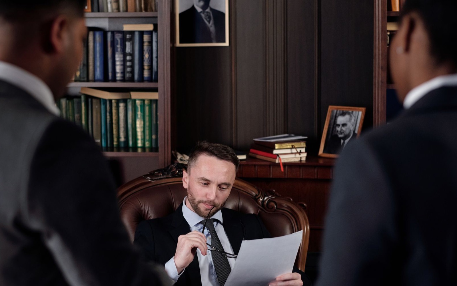 Legal professionals reviewing records in a library