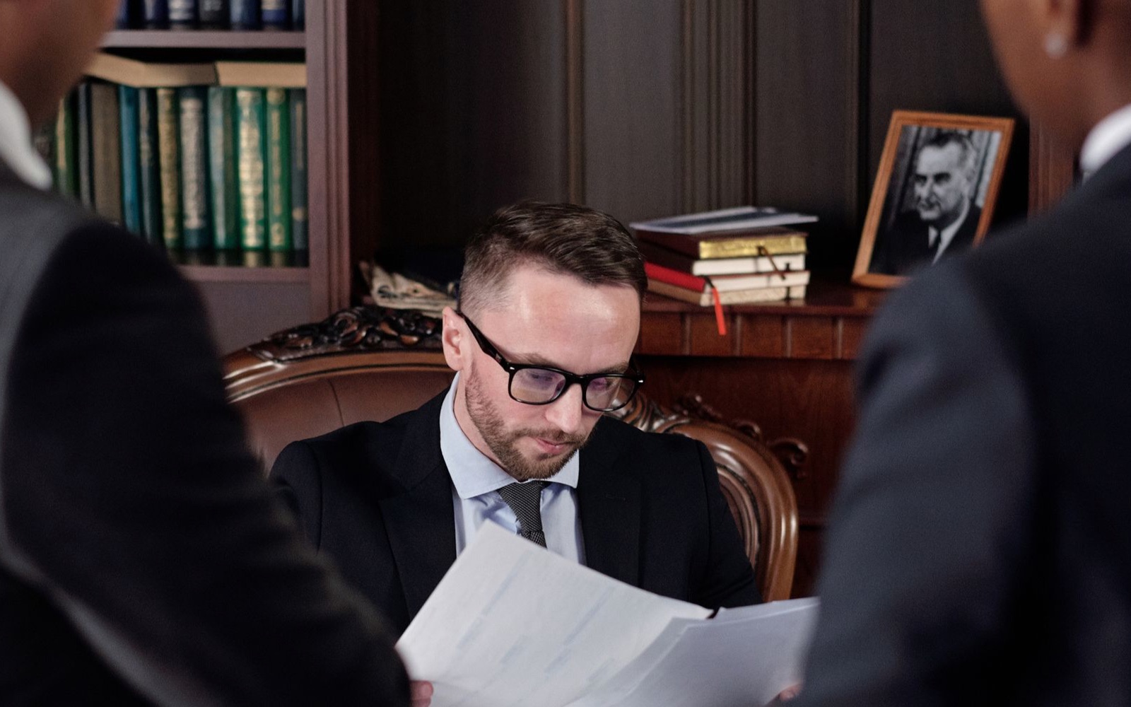 Legal advisors working through documents with their client